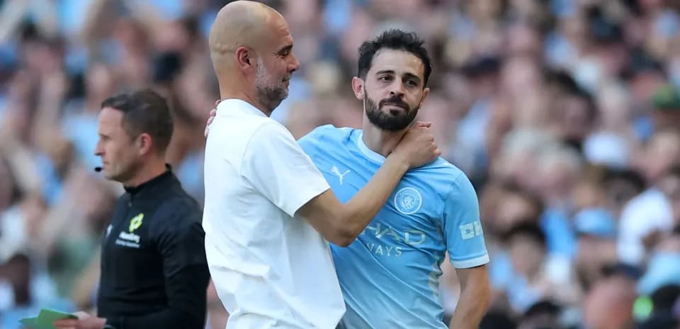 Pep Guardiola embracing Bernardo Silva on pitch