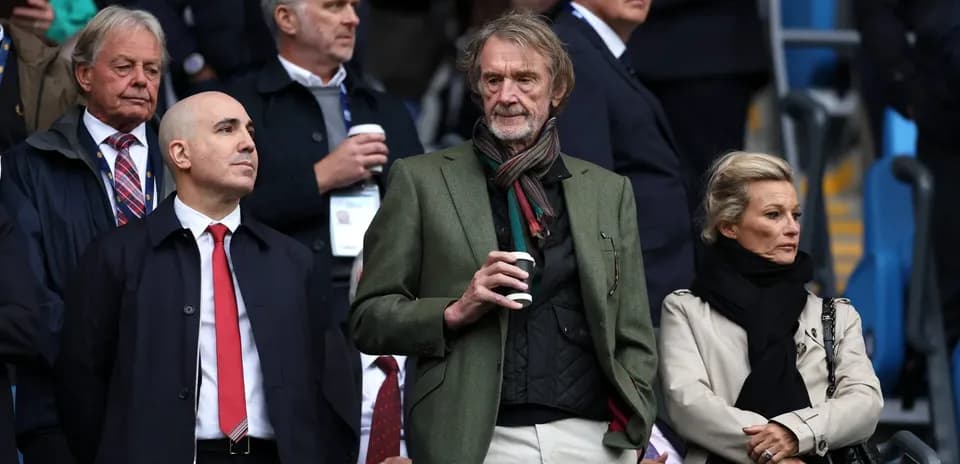 Four spectators watching a match in the stands