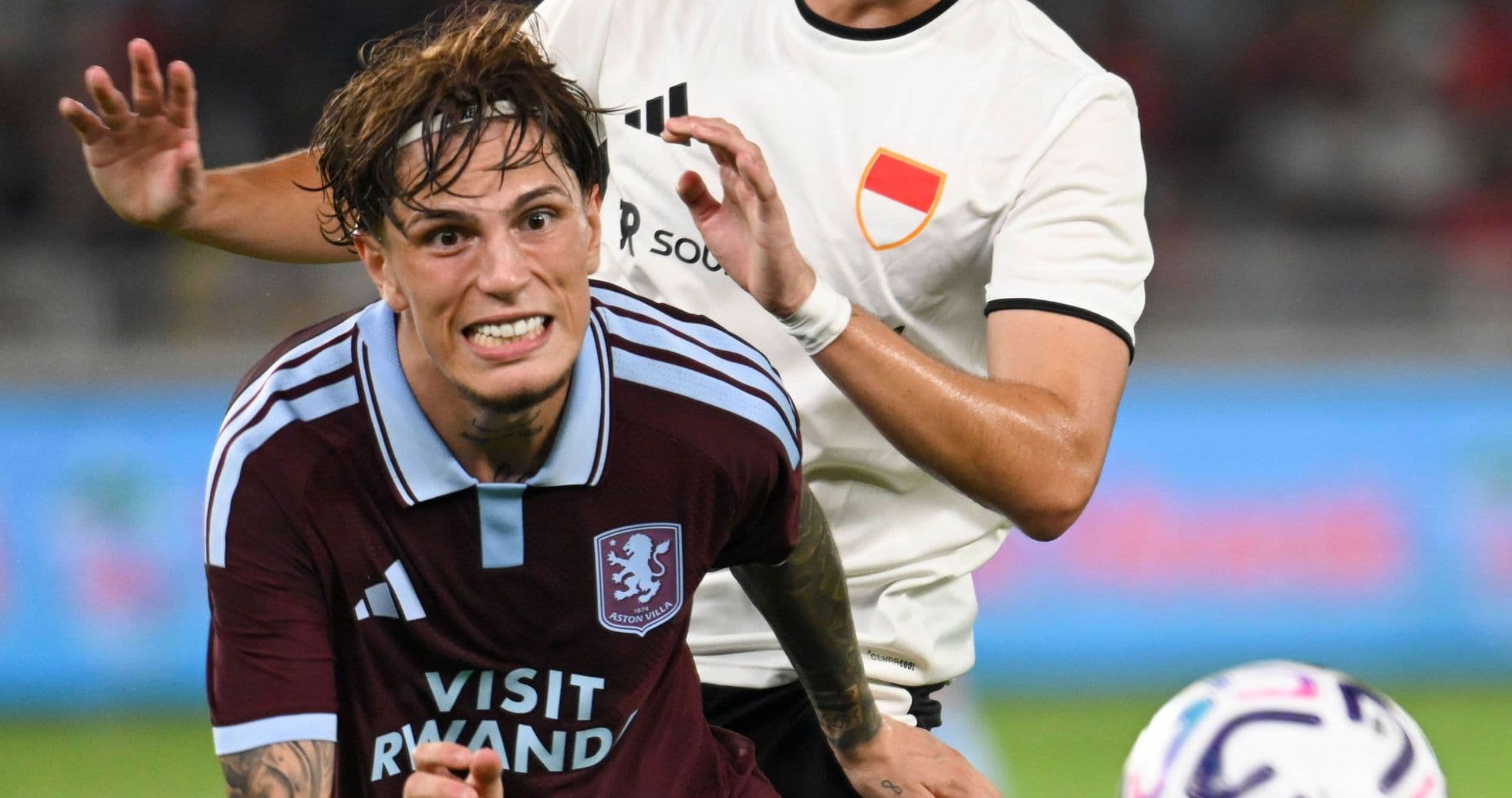 Игрок Aston Villa в борьбе с соперником на поле Игрок Aston Villa в борьбе с соперником на поле